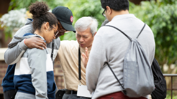 People praying, in a circle